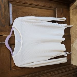 Cream colored sweater with side tie details